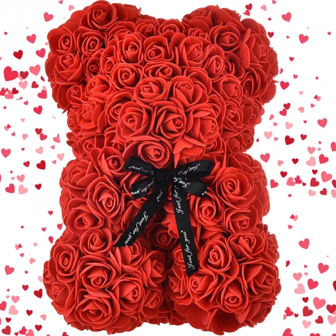 Ourson en pétales de roses dans une boîte cadeau