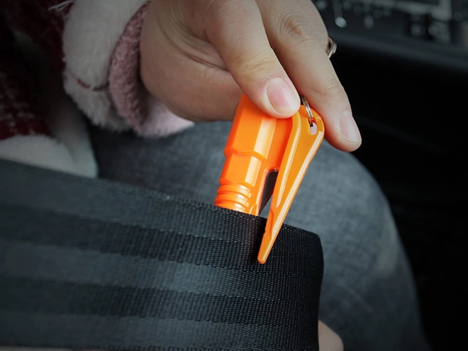 Integrated seatbelt cutter