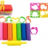 Set of colorful clays with cutters and roller in a plastic box